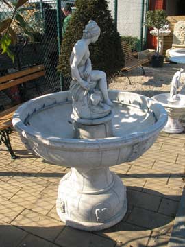 Fontaine de jardin en pierre avec une statue